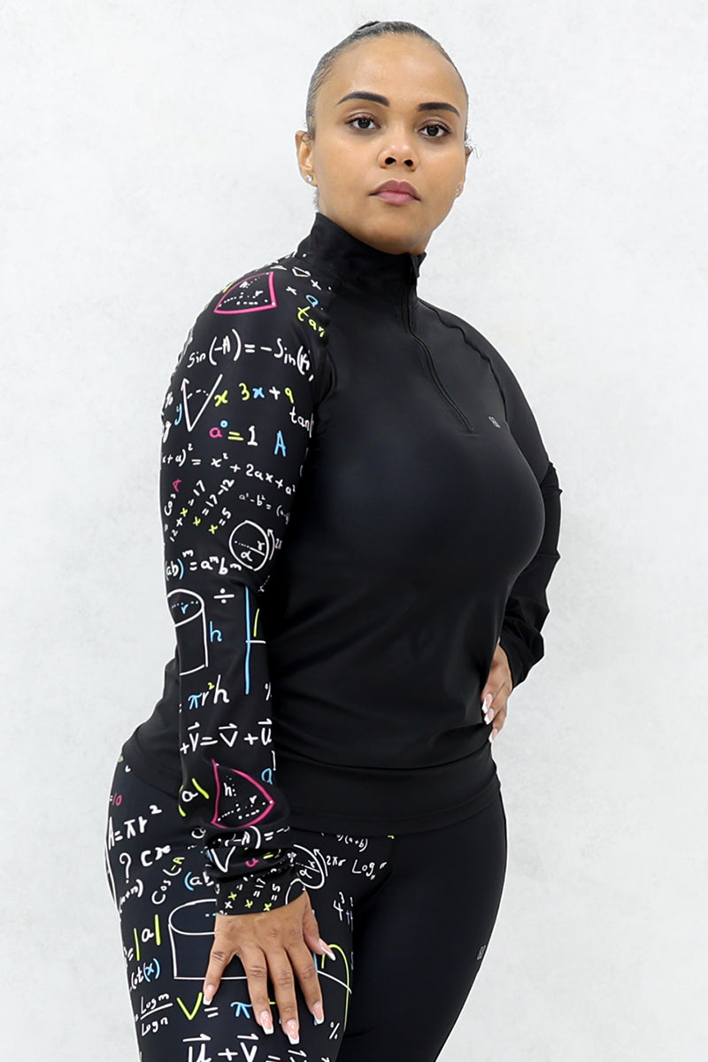 A woman wearing a black half-zip pullover with multicolor math equations printed on one side.