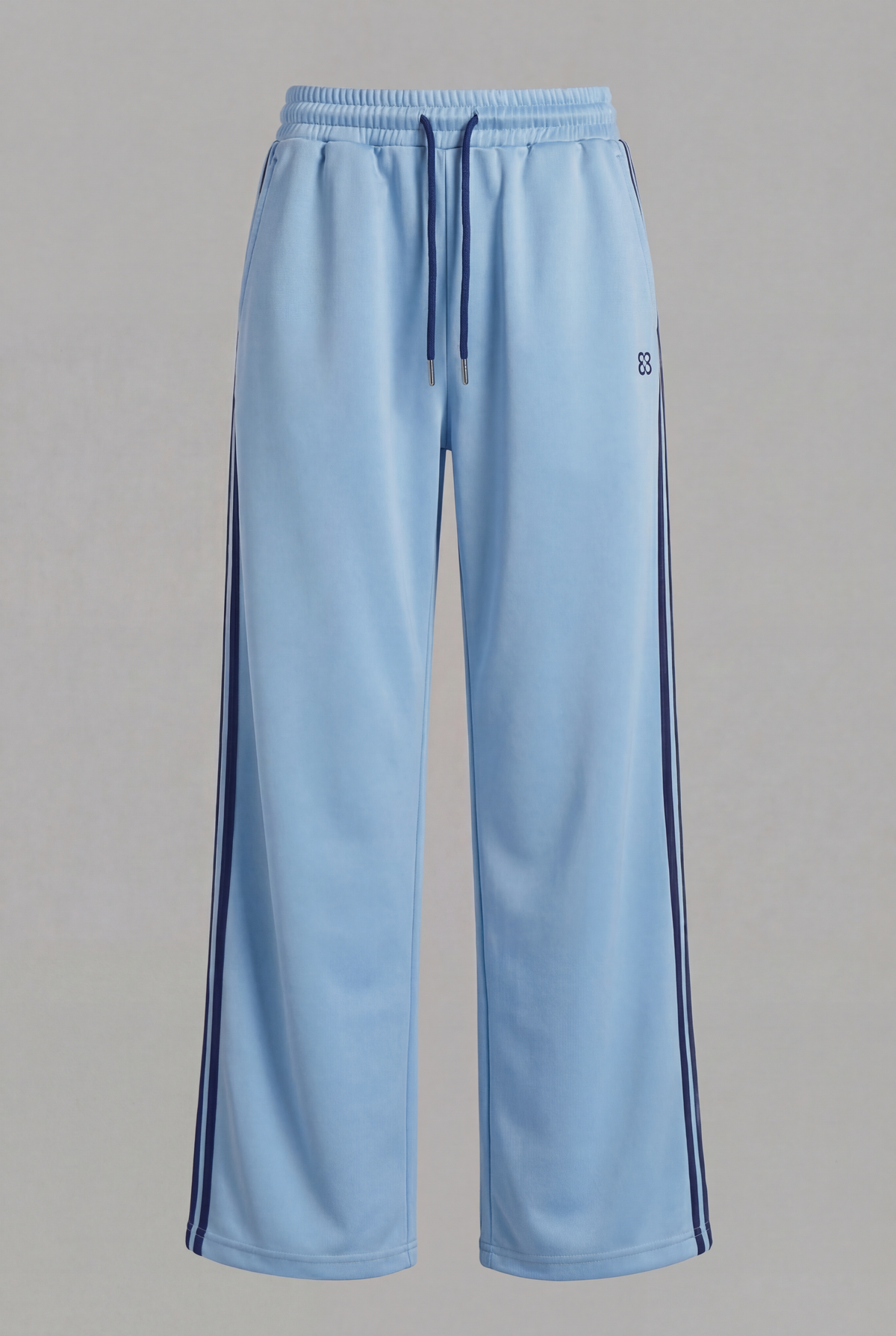 Front view of light blue track pants with navy drawstrings, logo, and side stripes.