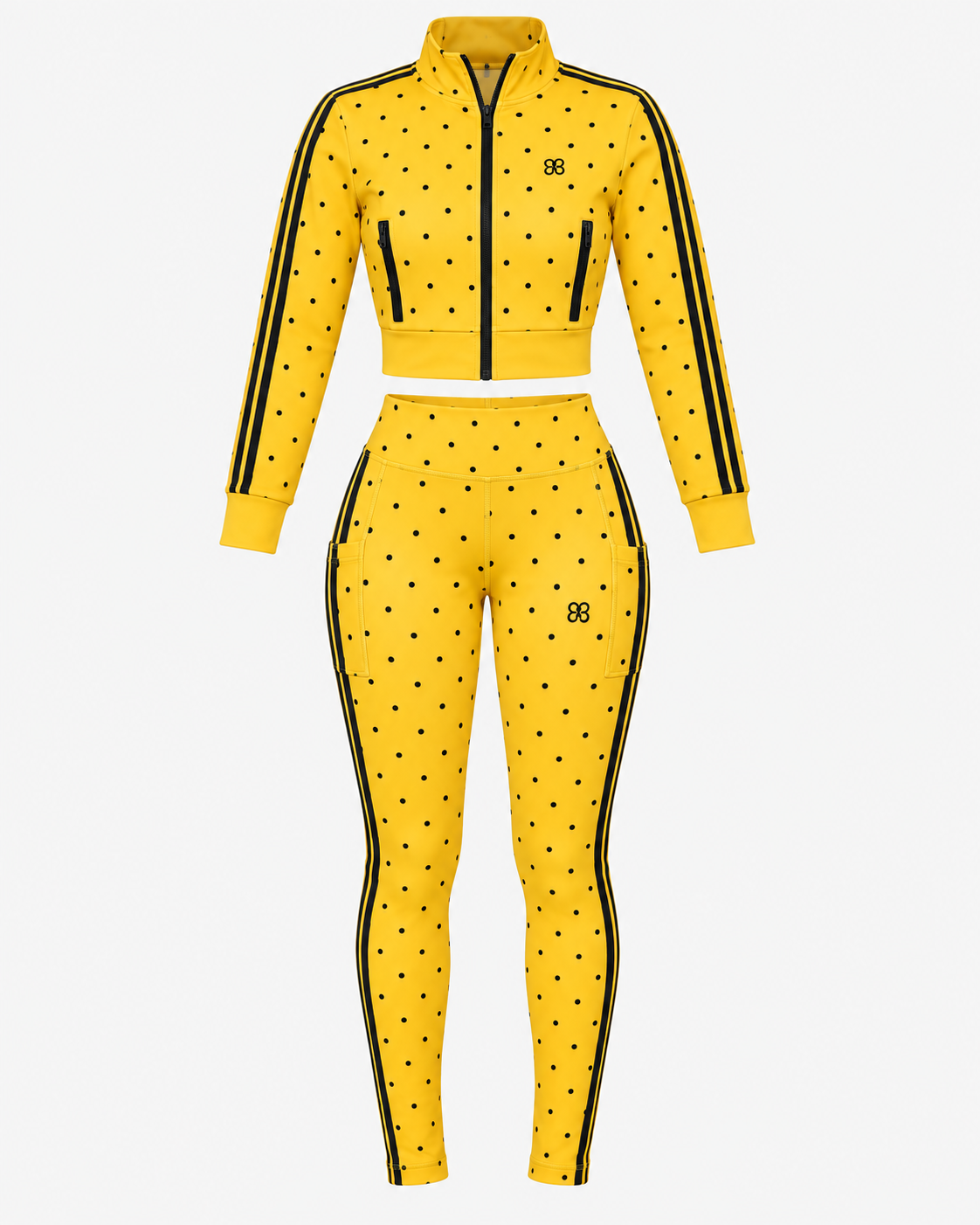 The Spotlight Jacket (SAMPLE SALE)—a yellow two-piece athletic outfit featuring black polka dots, black stripes on the sleeves and legs, a front zipper jacket, and matching high-waisted leggings—is displayed on a white background and available now at a discounted price.