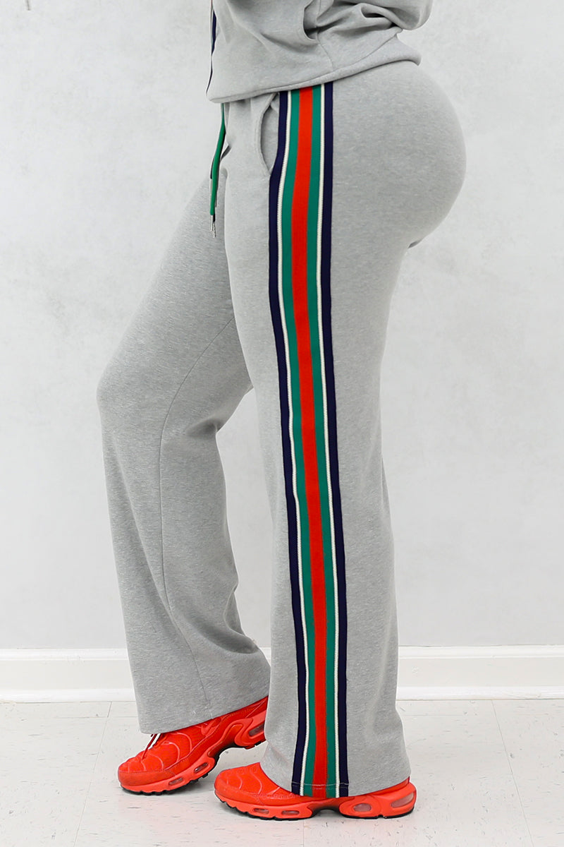 Woman wearing gray side stripe joggers with pockets