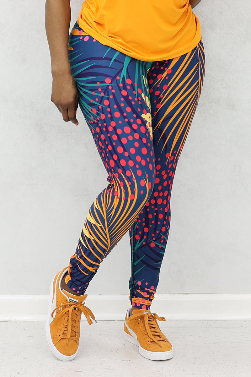 A woman wearing multi-colored Hawaii tights made of stretchy polyester and spandex, featuring a continuous drawstring.