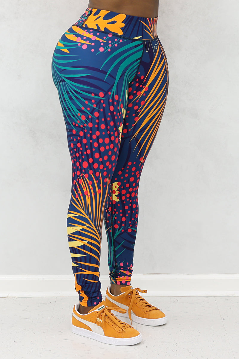 A woman wearing multi-colored Hawaii tights made of stretchy polyester and spandex, featuring a continuous drawstring.