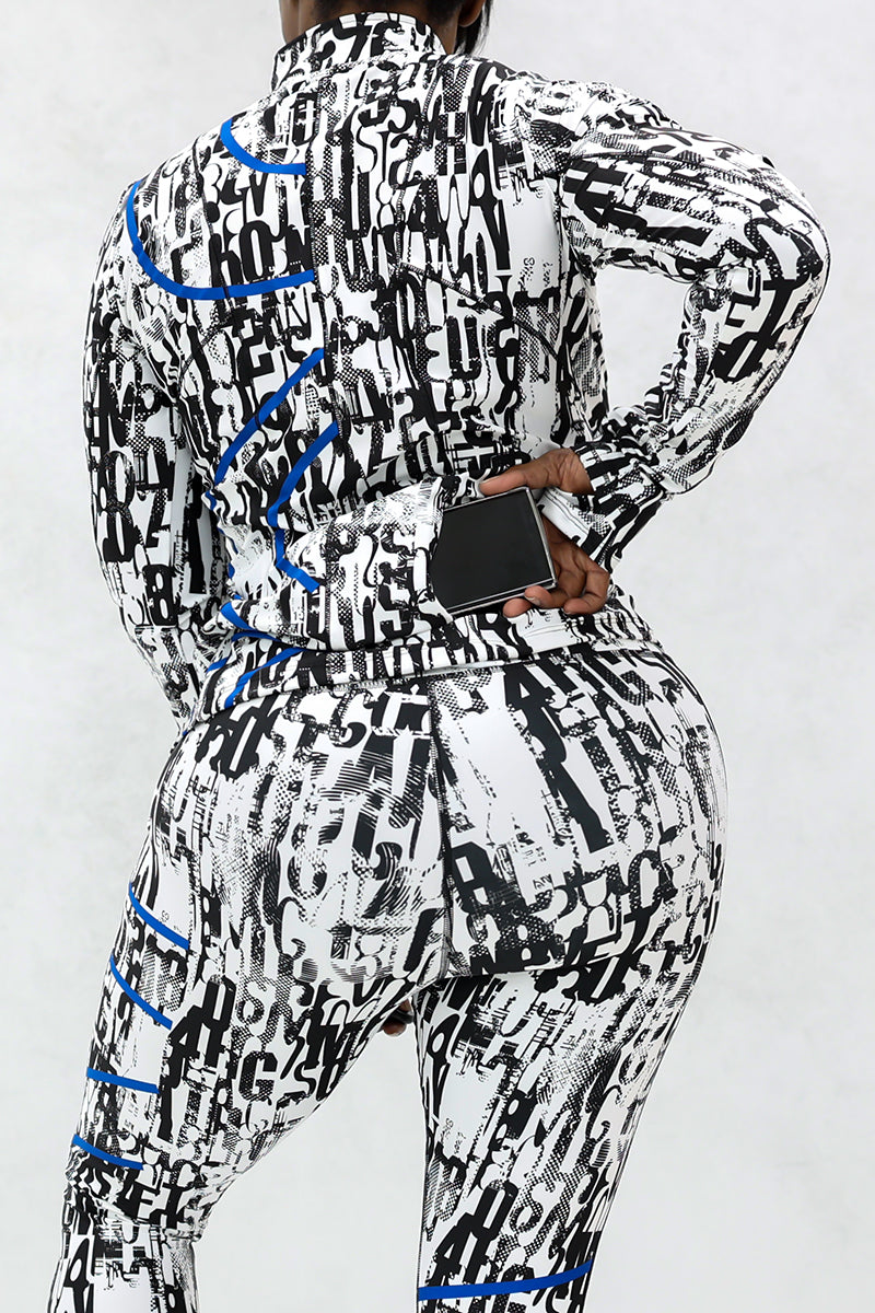A person wears the Blue Streak 1/2 Zip Pullover, featuring black, white, and blue letter patterns with thumbhole sleeves. They stand with their back to the camera, holding a black smartphone behind them in their right hand.
