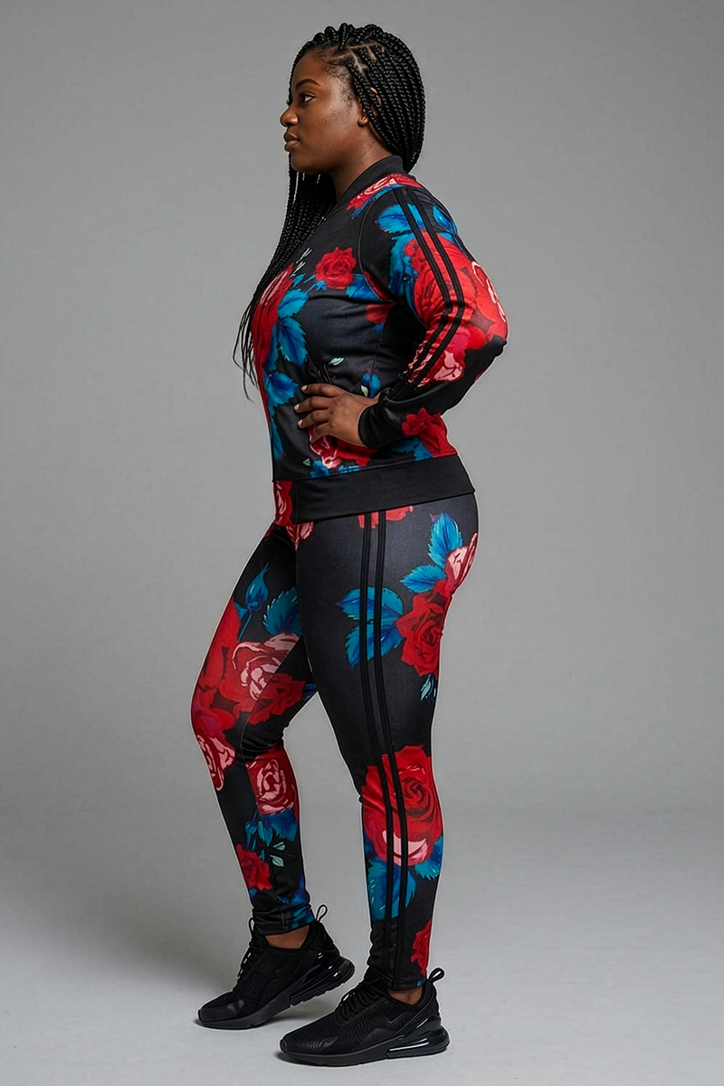 A woman stands in profile wearing Red Roses Tights with blue and red rose prints, black stripes, and a stretchy brushed fleece finish, paired with black athletic shoes, against a plain gray background.