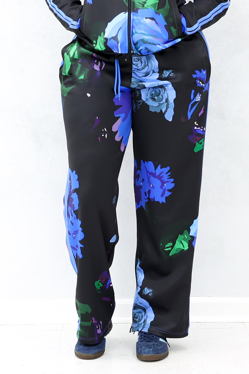 A front view of the black pants with blue roses. They are smooth, stylish, and comfortable.