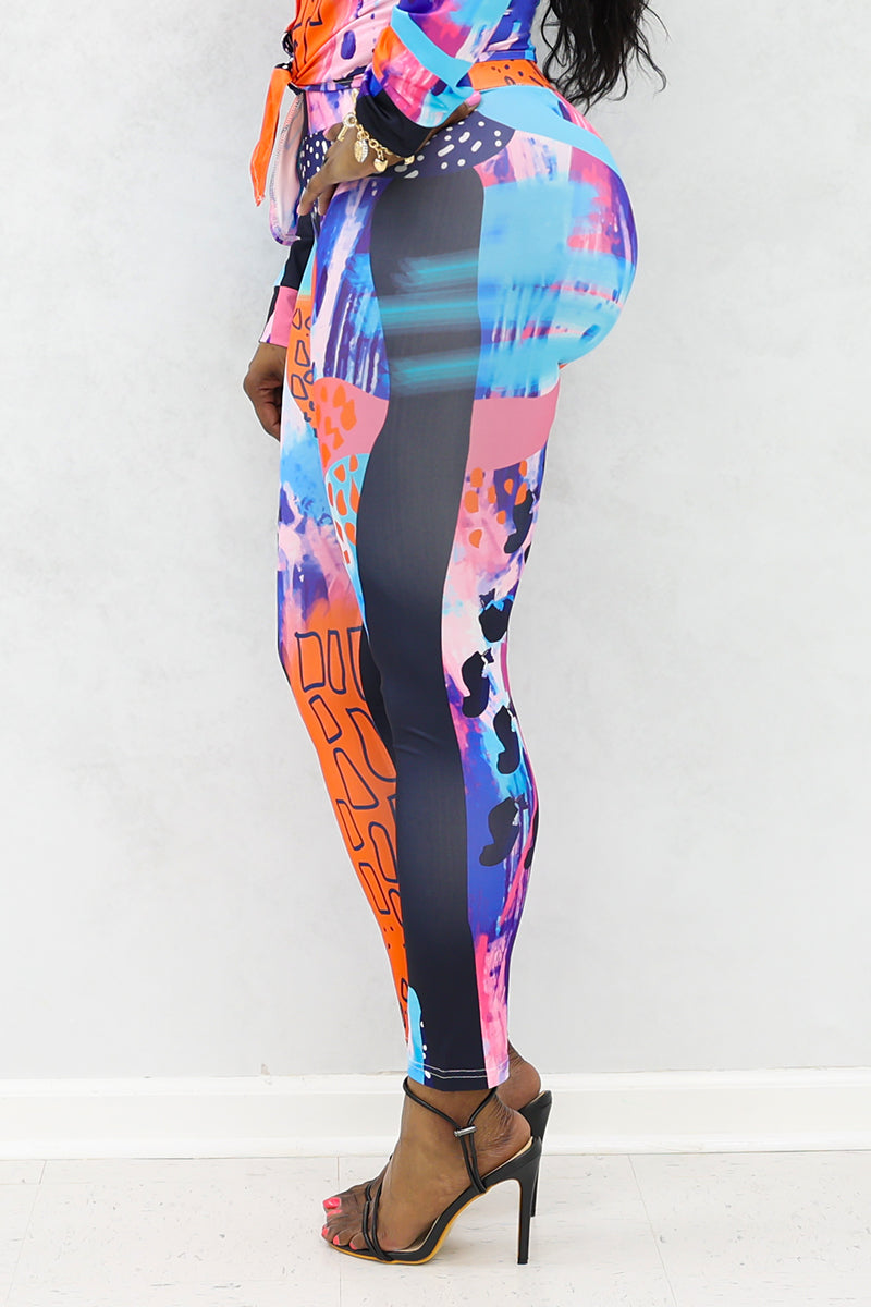 A woman wearing multi-colored Shante Leggings with a stretchy fabric and elastic waistband, perfect for comfort and style during workouts or casual outings.