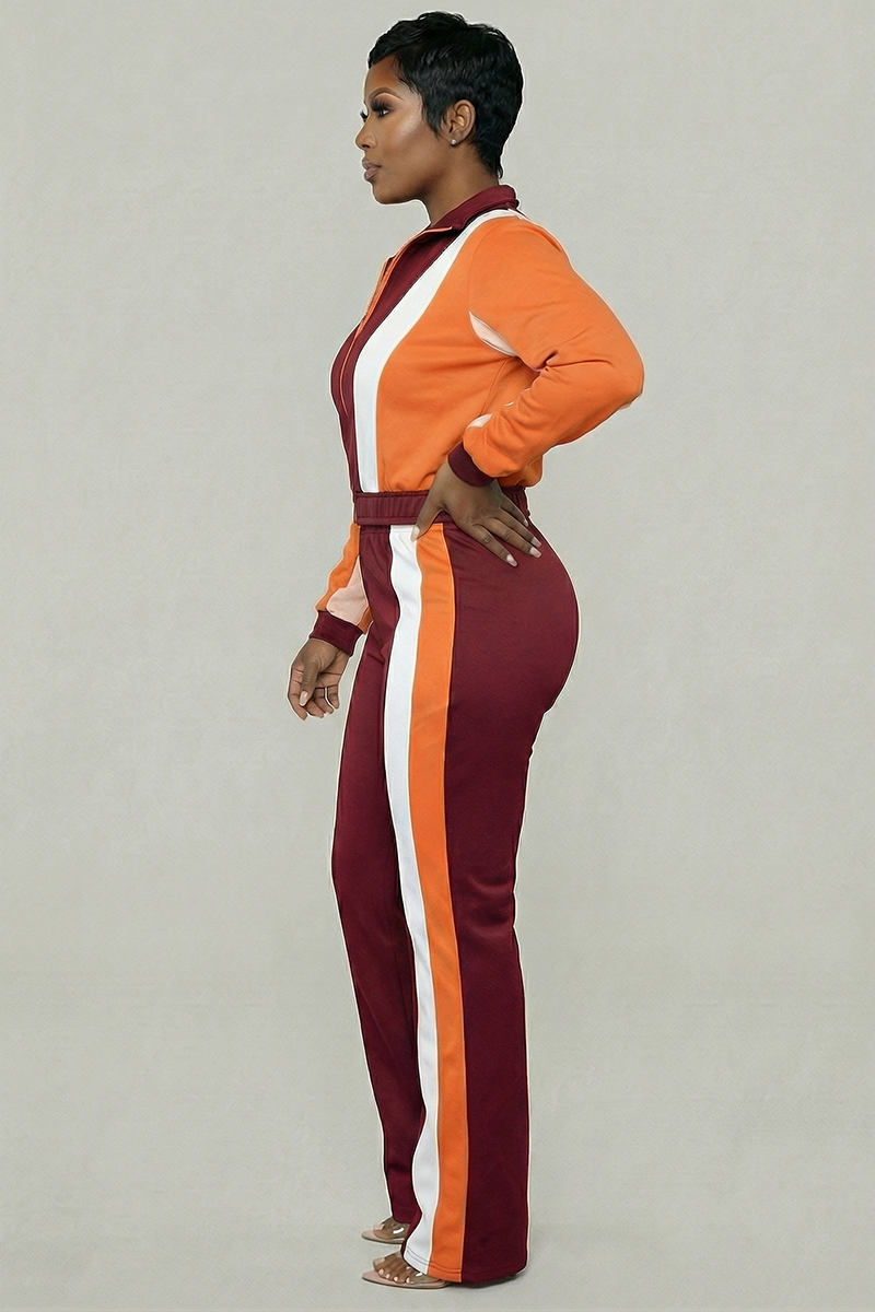 A person in a Color Block Cropped Jacket and matching pants with an elastic waistband stands in profile against a plain background; the outfit features orange, burgundy, and white vertical stripes.