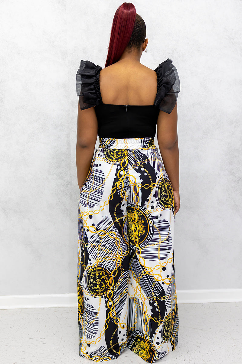 A woman wearing multi-colored Gold Chains palazzo pants featuring chic gold chains and a stylish wide-leg design.