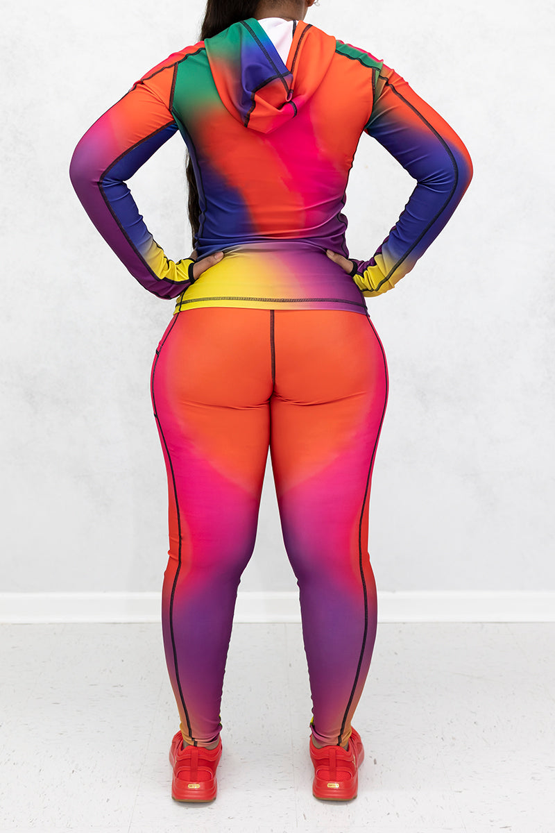 A beautiful woman wearing multi-colored Gradient Flow tights featuring a stylish gradient pattern for added flair.