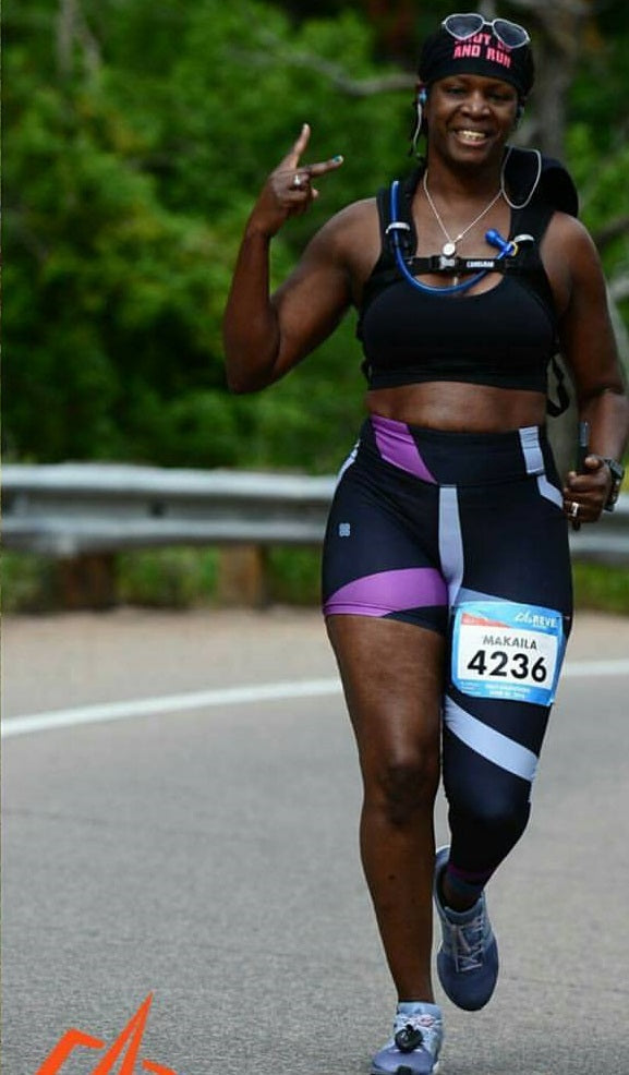 A woman wearing unique one-legged tights featuring vibrant ombre colors in  pink-purple designed for individuality and comfort during workouts.