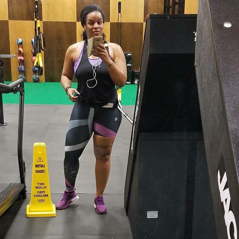 A woman wearing unique one-legged tights featuring vibrant ombre colors in  pink-purple designed for individuality and comfort during workouts.