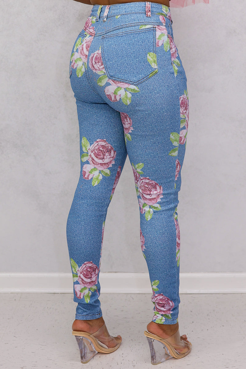 A stylish woman wearing multi-colored flower jeans with a trendy design.