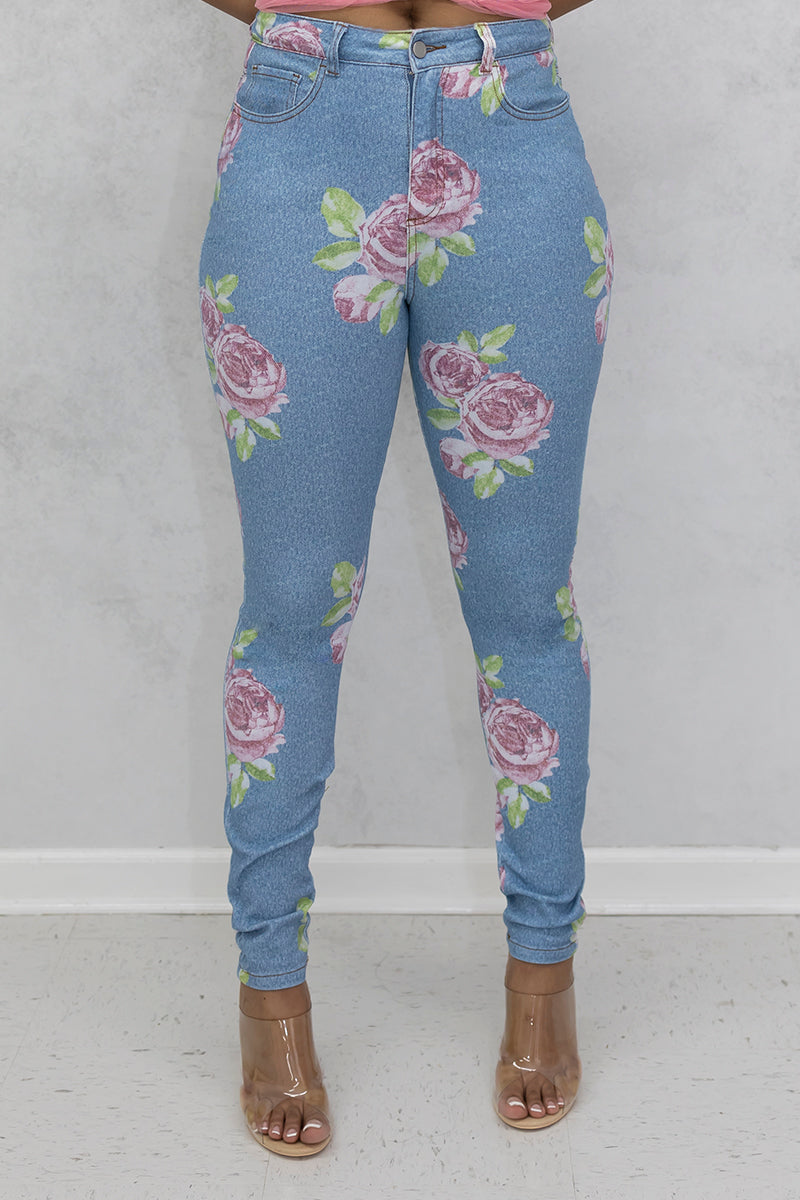 A stylish woman wearing multi-colored flower jeans with a trendy design.